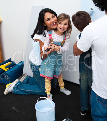 girl painting with her mother