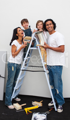 Smiling family painting a room