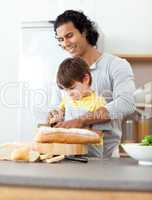 father cutting bread with his son