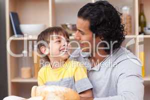 child eating bread with his father