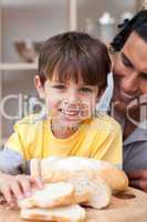 child eating bread with his father