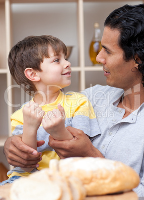 little boy and his father cutting bread