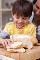 little boy eating bread with his father