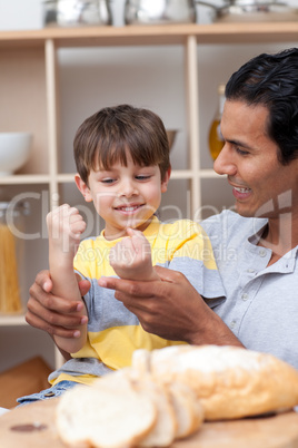 Father and son cutting bread