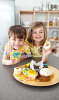 Adorable siblings showing their cookies