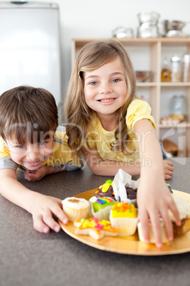 Brother and sister eating cookies