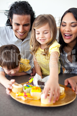 Jolly family eating cookies