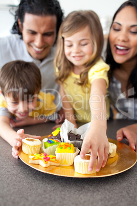 Joyful family eating cookies