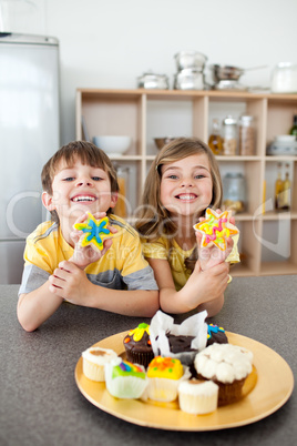 Cute siblings showing their cookies