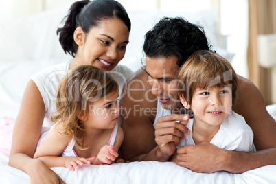 Animated family having fun lying on bed