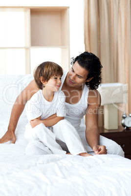 Adorable little boy talking with his father