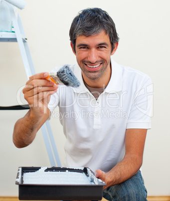 Attractive man painting a wall