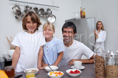 Smiling family having breakfast