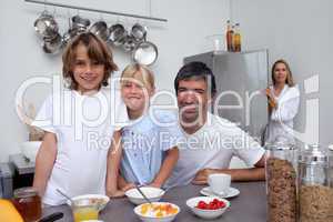Smiling family having breakfast