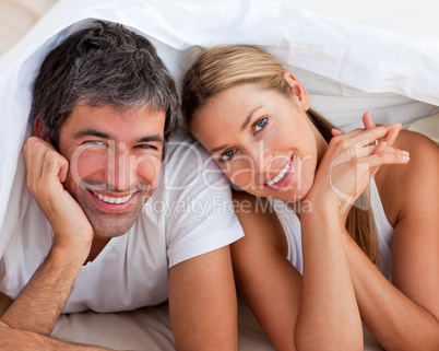 couple having fun lying on bed