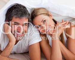 couple having fun lying on bed