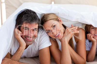 family having fun with on bed