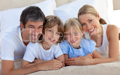 family having fun in the bedroom