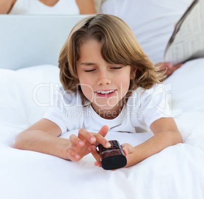 Smiling little boy watching TV