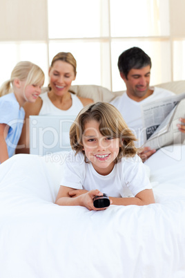 Enthusiastic little boy holding a remote