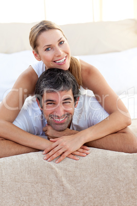Enamoured couple lying on the bed