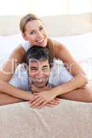 Enamoured couple lying on the bed