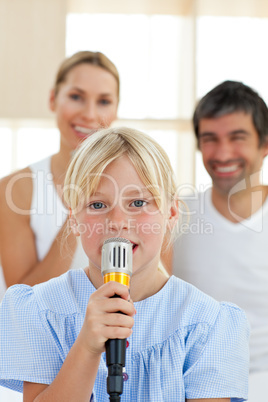 Adorable little girl singing with a microphone