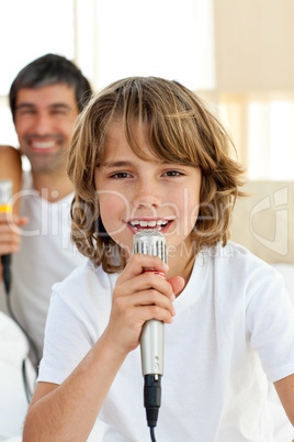 Little boy singing with a microphone