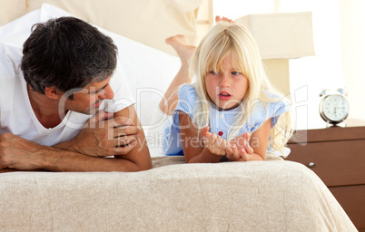 Little girl talking seriously with her father