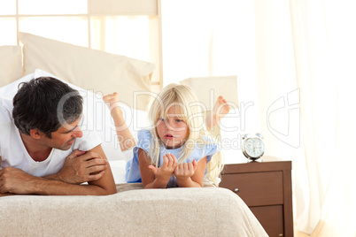 Adorable child having discussion with her father