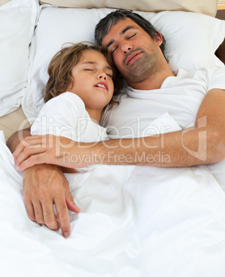 Affectionate father and his son sleeping together