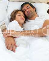 Affectionate father and his son sleeping together