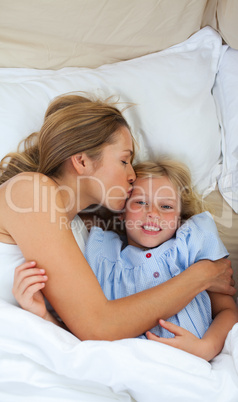 Affectionate mother kissing her daughter