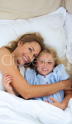 Attractive mother hugging her daughter