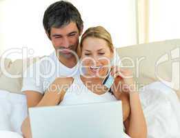 Jolly couple buying on internet