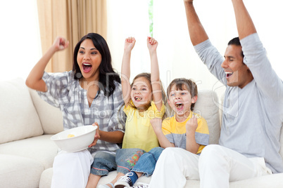 Animated family watching TV on sofa