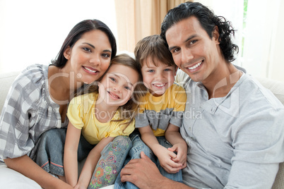 Portrait of a smiling family sitting on sofa