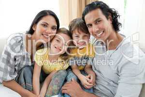 Portrait of a smiling family sitting on sofa