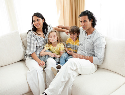 Portrait of a family sitting on sofa