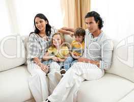 Portrait of a family sitting on sofa