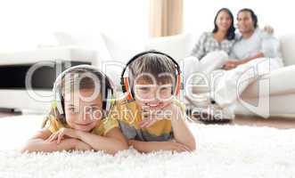 Adorable siblings listening music with headphones