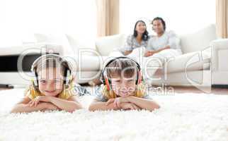 Cute siblings listening music with headphones