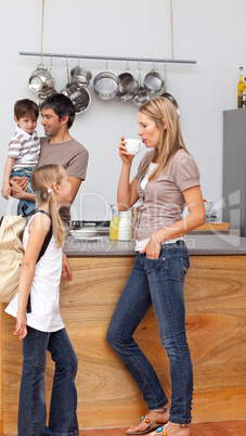 Family talking in the kitchen before school