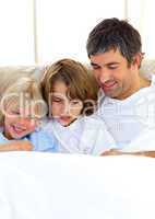 Attentive father and his children reading book