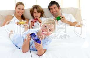 Little blond girl playing video game with her family