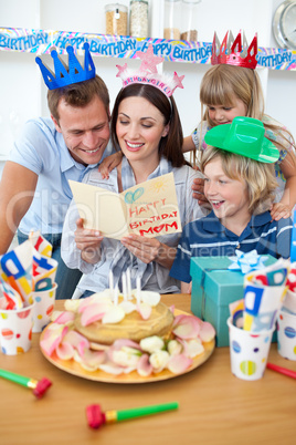 Joyful family celebrating mother's birthday