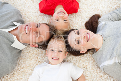 Jolly family lying on the floor