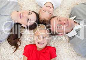 Merry family lying on the floor
