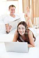 Pretty woman with her husband working at a laptop