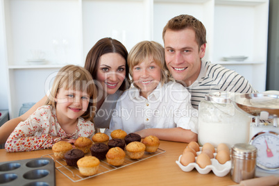 Happy family presenting their muffins